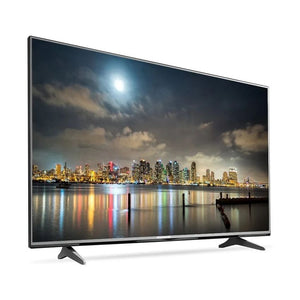 Curved TV displaying a city skyline at night with a moonlit sky.